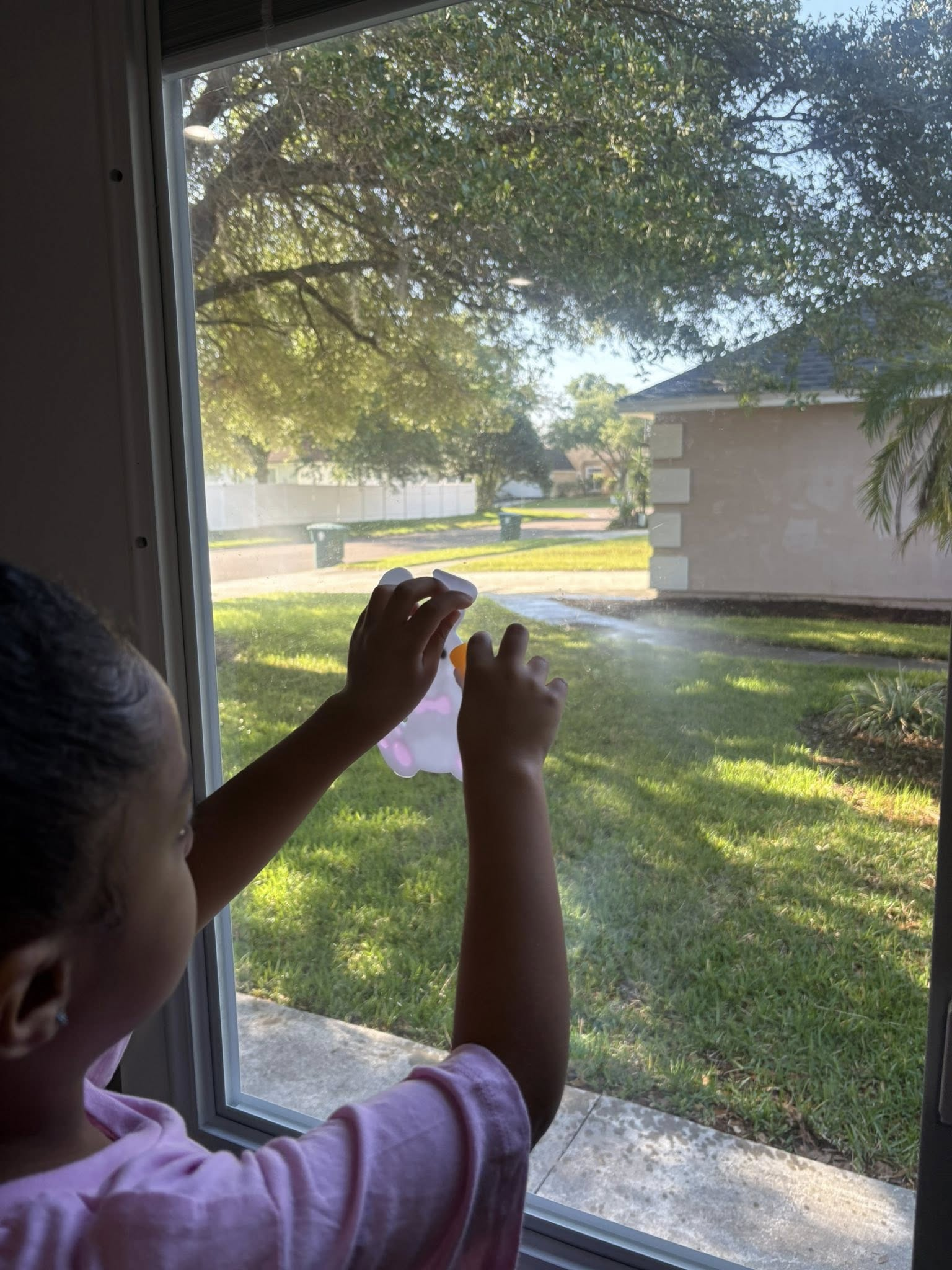 Child exploring near a sunlit window